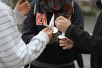 Students help each other light their candles. Photo by Gabriela Jeronimo.