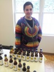 Anna Alfonso, an avid supporter of Evolutionary Organics, stands with simple syrups made at the farm. Photo by Kelly Fay.