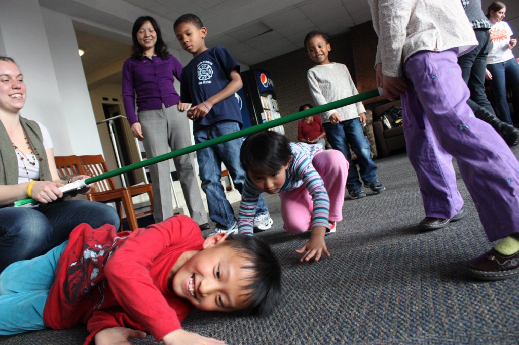 Siblings, Tyler and April Wong, 8 and 5, get creative in a game of ‘limbo.’ Photo by Lauren Reid.