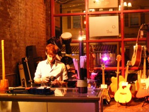Tyler Beatrice behind the counter of his newly opened guitar shop, Root Note Music. Photo by Dan O'Reagan.