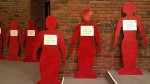 At least 15 human-sized cardboard cutouts, spray painted red, lined a wall of the room. Attached to each cutout was a sheet of paper that listed a woman’s name, the date of her murder, and what town or county it occurred in. Photo by Hannah Nesich.