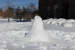 SUNY New Paltz students build a snowman outside their residence hall. Photo by Kate Bunster.